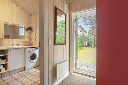 a kitchen with a washer and dryer in a house at 20311-Samso-Havvejen-87 in Sælvig
