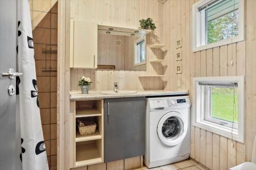 a bathroom with a washing machine in a tiny house at 20311-Samso-Havvejen-87 in Sælvig