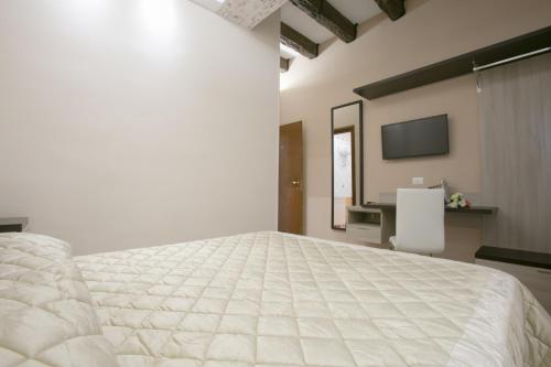 Postel nebo postele na pokoji v ubytování Hotel la Fenice