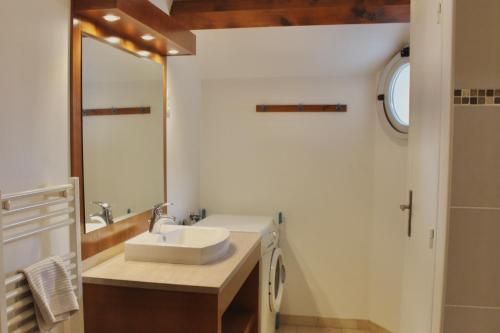 a bathroom with a sink and a mirror at La Bullote - Gîtes - Paris Roissy CDG in Villeneuve-sous-Dammartin