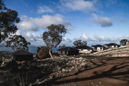 a group of houses on the side of a hill at Mount Rumney Escapes - 5 Seaview Kangaroo House in Mount Rumney