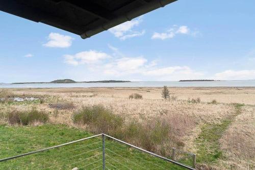 a fence in a field with the ocean in the background at 20420-Samso-Alstrup-15-C in Toftebjerg