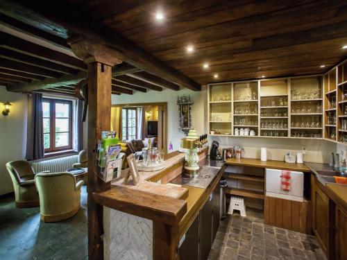 a large kitchen with wooden ceilings and wooden counters at Holiday Home in Alveringem near Coast in Leisele