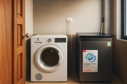 a washing machine and a trash can in a bathroom at Close to My Khe Beach I Food street I Sóng Homestay in Da Nang