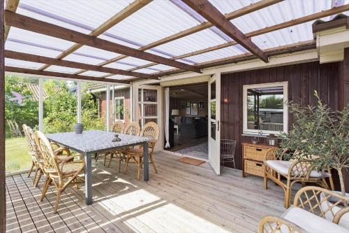 a pergola on a deck with a table and chairs at AE242-Aeroskobing-Borgnaesvej-11 in Ærøskøbing