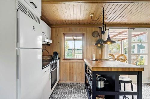 a kitchen with a white refrigerator and a counter at AE242-Aeroskobing-Borgnaesvej-11 in Ærøskøbing
