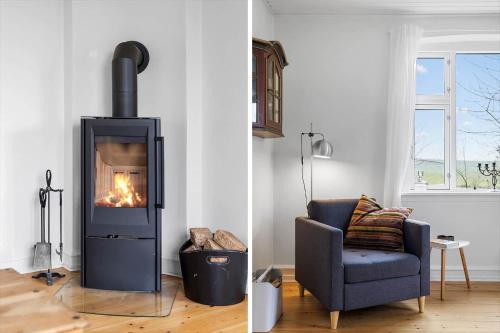 a living room with a fireplace and a chair at AE307-Soby-Aero-Godthab-2 in Leby