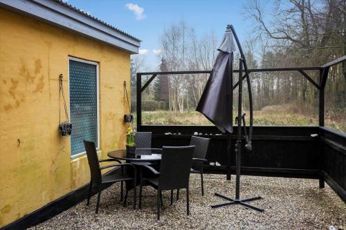 a patio with a table and an umbrella at AE307-Soby-Aero-Godthab-2 in Leby