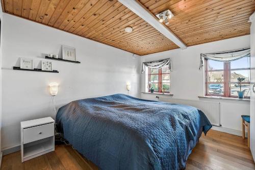 a bedroom with a bed and a wooden ceiling at AE216-Marstal-Hovedgaden-27 in Marstal