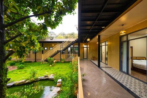 a house with a pond in the middle of it at Lumiere Family Village Long Khánh - Đồi Rìu in Long Khanh