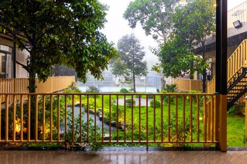 a yellow fence in front of a yard at Lumiere Family Village Long Khánh - Đồi Rìu in Long Khanh