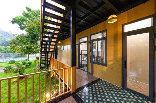 a house with a balcony with a door and a view at Lumiere Family Village Long Khánh - Đồi Rìu in Long Khanh