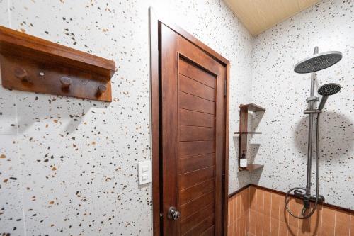 a room with a wooden door and a wall at Lumiere Family Village Long Khánh - Đồi Rìu in Long Khanh