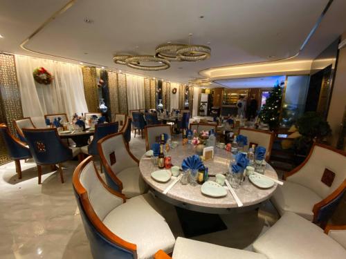 a dining room with a large table and chairs at Flower Hotel Ulaanbaatar in Ulaanbaatar