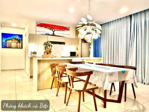 a kitchen and dining room with a table and chairs at Oceanami Villas & Beach Club in Long Hai