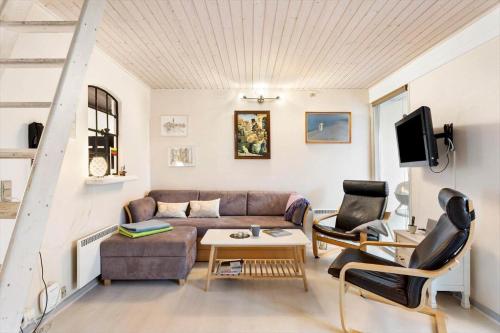 a living room with a couch and two chairs at AE298-Aeroskobing-Rosenstraede-36 in Ærøskøbing
