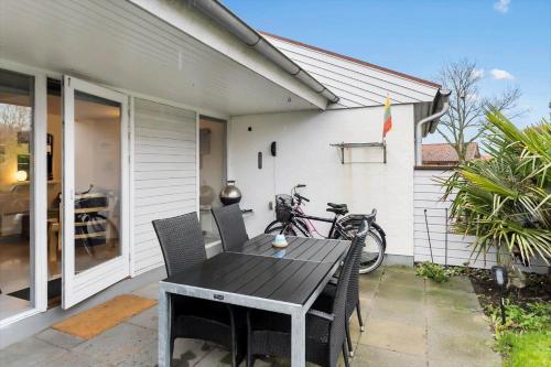 a patio with a table and chairs in front of a house at AE298-Aeroskobing-Rosenstraede-36 in Ærøskøbing
