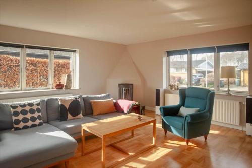 a living room with a couch and a chair at AE265-Aeroskobing-Sotoften-12 in Ærøskøbing