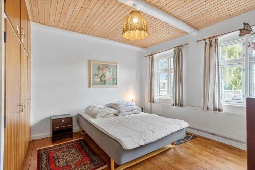 a bedroom with a bed in a room with windows at AE219-Marstal-Ommelsvejen-14 in Marstal