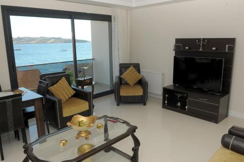 a living room with a view of the ocean at Saatli Suites in Cesme