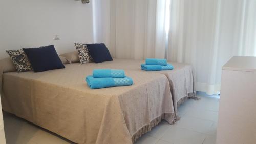 two blue pillows sitting on a table in a room at Playmar Sun Maspalomas in Playa del Ingles