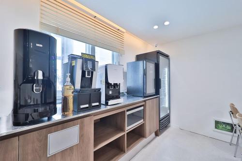 a room with a counter with three microwaves at Hotel Onna Haeundae in Busan