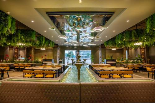 a banquet hall with tables and a fountain in the middle at Hotel La Arriba in Ahmedabad