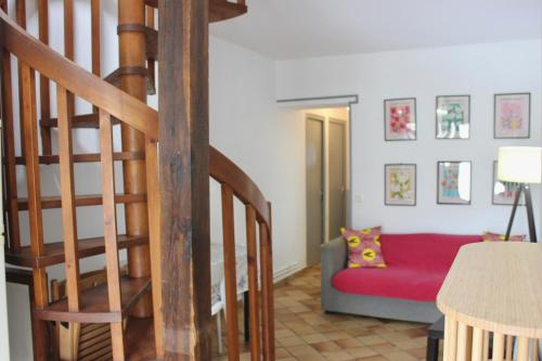 a living room with a staircase and a couch at La Bullote - Gîtes - Paris Roissy CDG in Villeneuve-sous-Dammartin