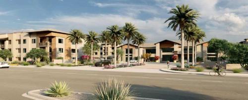 a man riding a bike down a street with palm trees at Luxury Resort Style 2Bedroom 2Bath Desert Oasis Desert Ridge in Phoenix