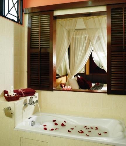 a bathroom with a tub with roses on the floor at A'Famosa Resort Melaka in Melaka