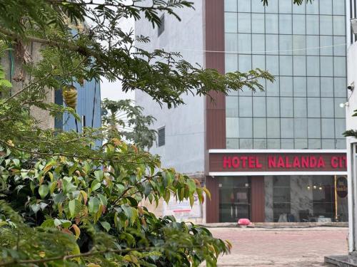 a hotel malawi girl sign in front of a building at Hotel Nalanda City in Nalanda