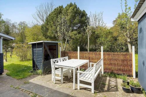 a picnic table and two benches in a yard at AE237-Aeroskobing-Hanses-Ager-19 in Ærøskøbing