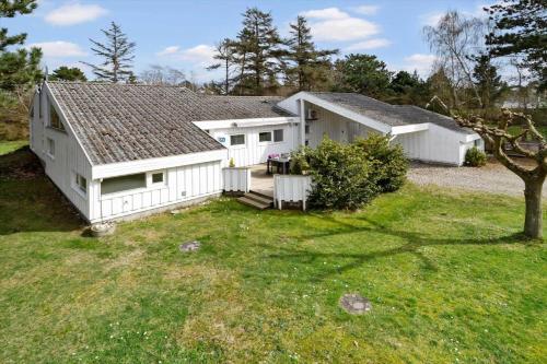 a large white house with a yard at 20128-Samso-Maarup-Osterstrand-60 in Nordby