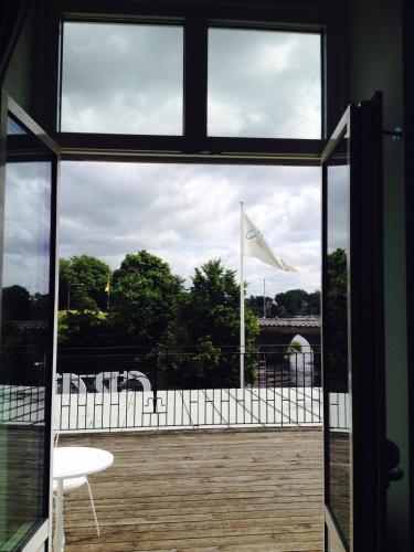 an open window with a view of a flag at Grand Hotel Falkenberg in Falkenberg