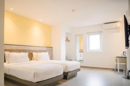 Ένα ή περισσότερα κρεβάτια σε δωμάτιο στο Amaris Hotel Ambon