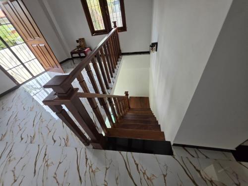 a staircase in a house with marble flooring at Saran villa in Kochchikade