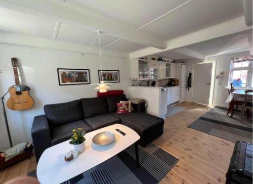 a living room with a couch and a table at AE302-Aeroskobing-Smedegade-19 in Ærøskøbing