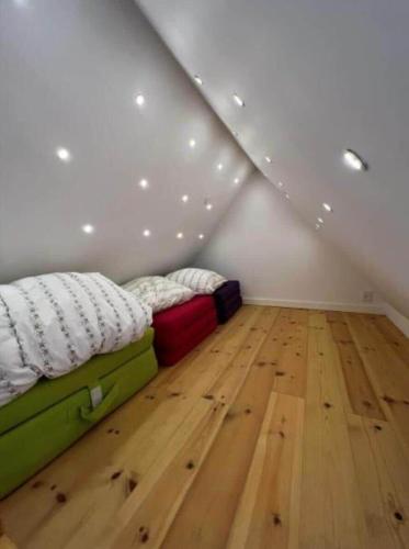 a bedroom with a bed and a wooden floor at AE302-Aeroskobing-Smedegade-19 in Ærøskøbing
