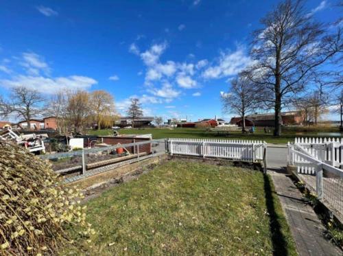 a white fence in a yard with a field at AE302-Aeroskobing-Smedegade-19 in Ærøskøbing
