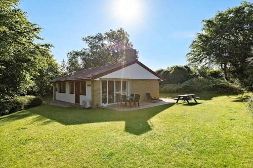 a small house with a picnic table in a yard at SB50374-Aabenraa-Kloften-35 in Aabenraa