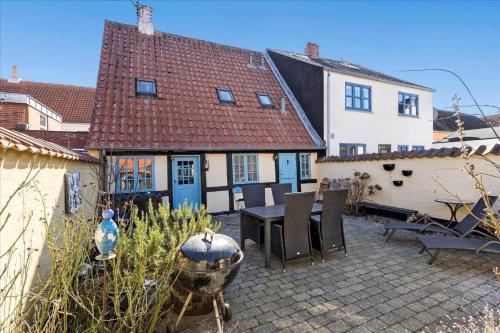a house with a patio with a table and chairs at AE213-Marstal-Strandstraede-2 in Marstal
