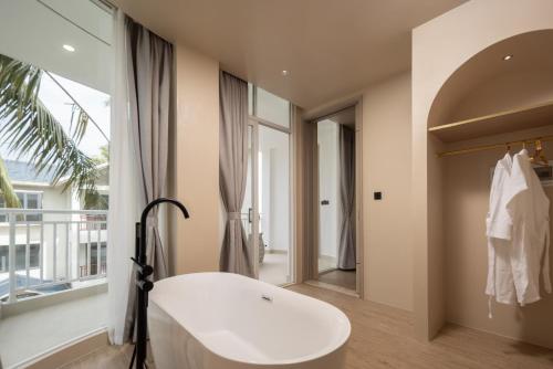 a bathroom with a white tub and a window at Langying Intelligent Guesthouse in Changshancun