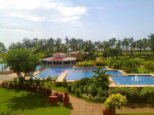 an aerial view of a resort with a swimming pool at The LaLiT Golf & Spa Resort Goa in Canacona