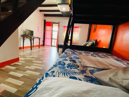 a bedroom with a bed in a room at Mekeni transient house and restaurant in Pagudpud