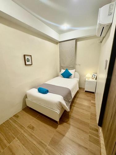 a small bedroom with a bed and a tv at Hip Hostel - SHA Plus in Patong Beach