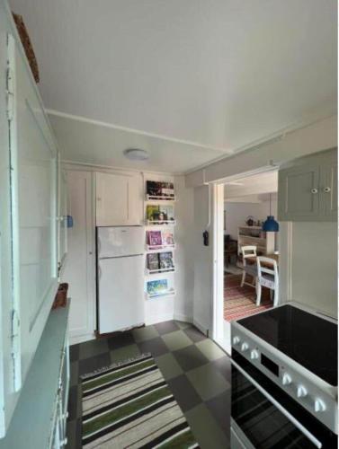 a kitchen with a white refrigerator and a table at AE261-Aeroskobing-Sondergade-50 in Ærøskøbing