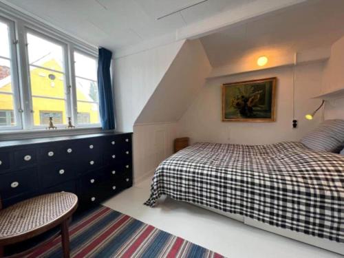 a small bedroom with a bed and a window at AE261-Aeroskobing-Sondergade-50 in Ærøskøbing