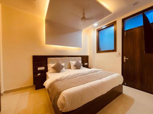 a bedroom with a large bed and a window at The Divine Ganga - Preferred Choice for Families with Cozy Rooms in Haridwār