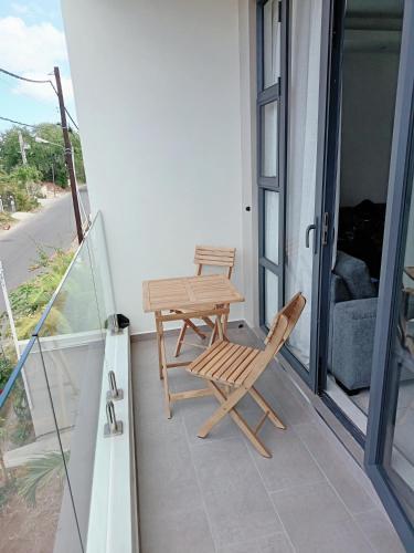 a patio with a table and chairs on a balcony at Apartment in Flic en Flac - Pearl Side Residence 101 in Flic-en-Flac