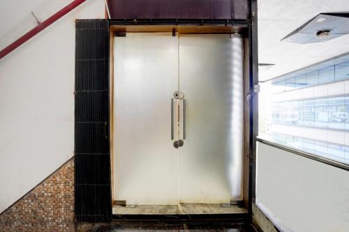 a metal door in a building with a staircase at Super Collection O Kosad Railway Station Formerly Hotel Royal Orbits in Jāmb